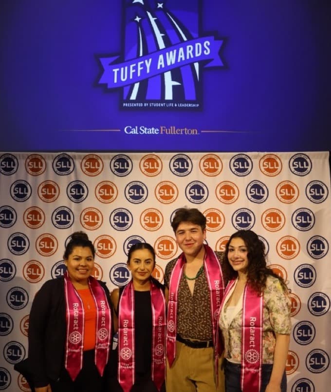 The Rotaract CSUF team at the Tuffy Awards backdrop, with Leah Korenberg at right