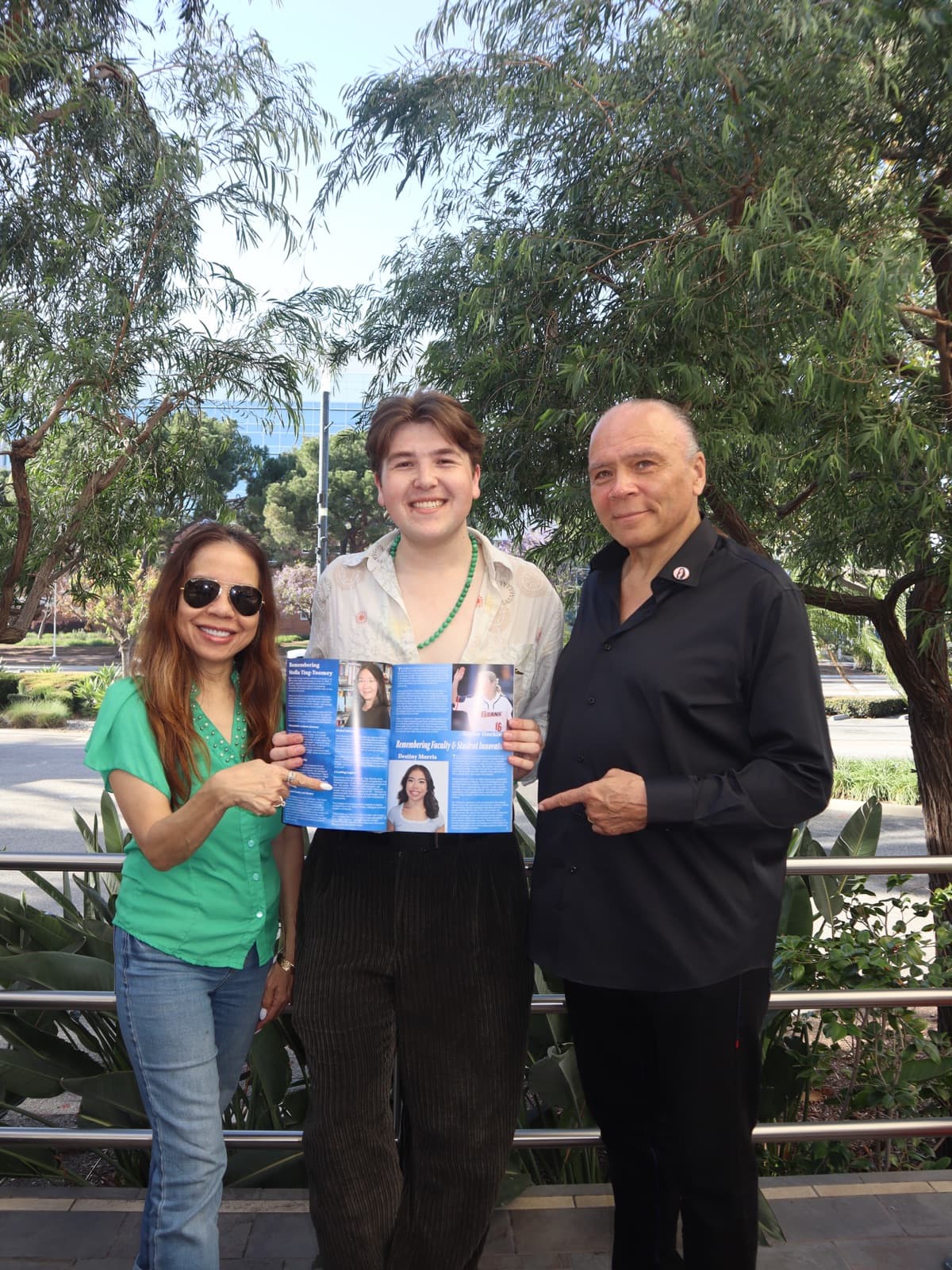 Gregory Ferraro with Destiny Morris’ family at the ProComm launch, holding the issue open to her memorial · 12
